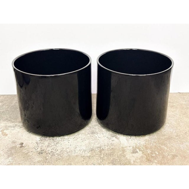 A pair of Gainey Ceramics black glazed ceramic planters. Both planters are in good condition with no chips, cracks or...