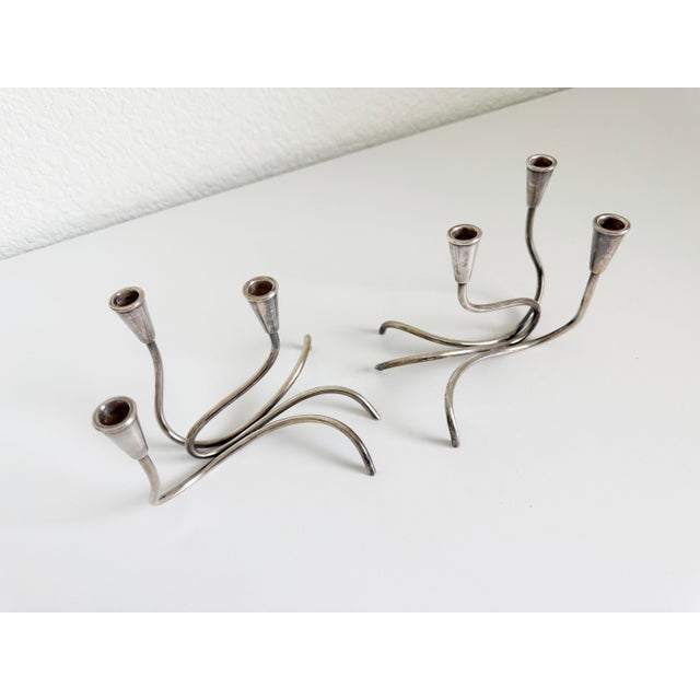 A pair of mid-20th-century modernist candle holders crafted in Copenhagen, Denmark by silversmith Carl F. Christiansen....