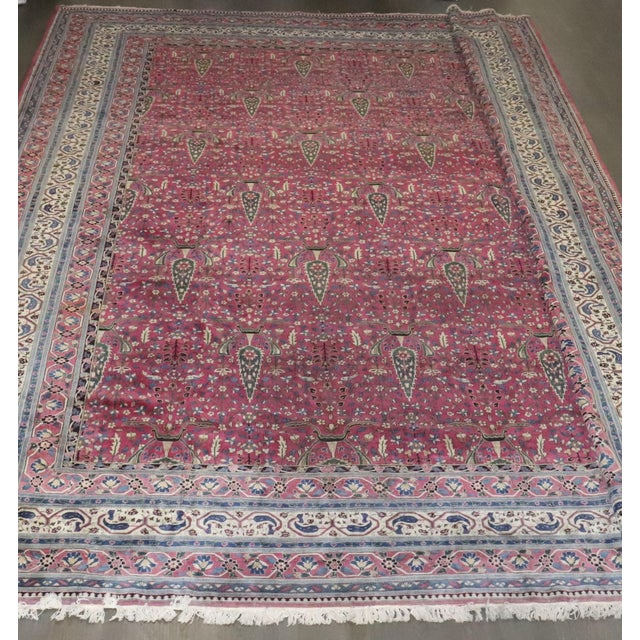 A large early 20th Century Indian Larestan Size Adjusted Rug in a predominant plum color