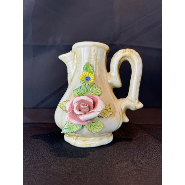 This exquisite vintage Italian flower pitcher vase, designed in the iconic Capodimonte style, is a stunning blend of...