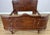An elegant Vintage French Louis king size bed featuring a beautifully shaped headboard and footboard, flowing curved...