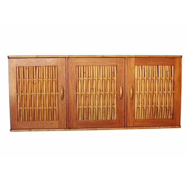 This Mid-century Mahogany Sideboard w/ Woven Rattan Doors is an original Hawaii “Kamaaina Family” custom-commissioned...