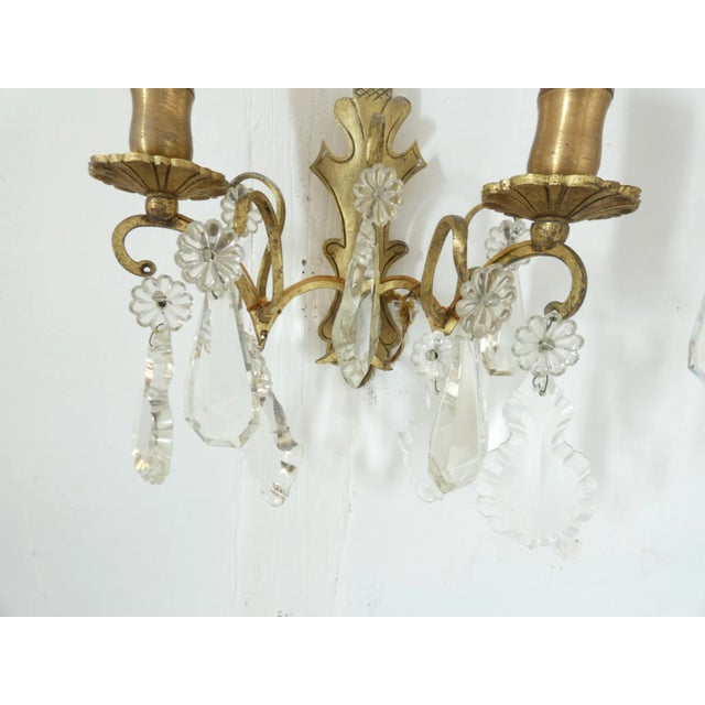 One pair of bronze appliqués or wall sconces. They have an etched curved base and all the crystal sconces are intact....