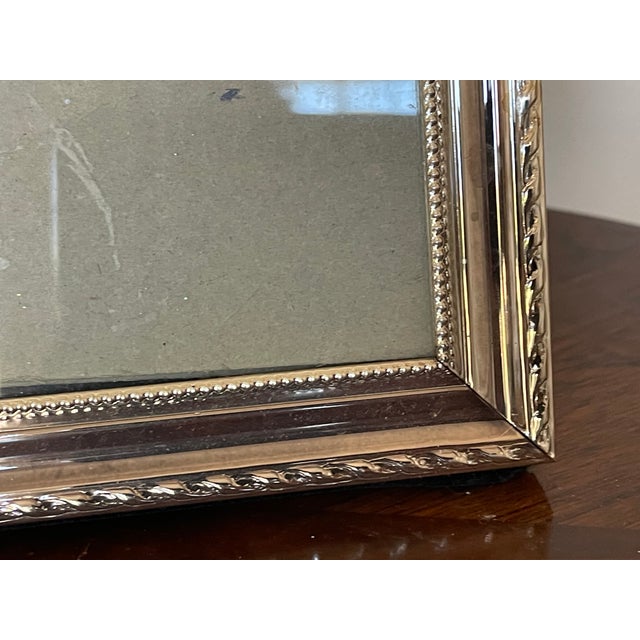 Traditional elegant silverplate photo frame with ornate border.