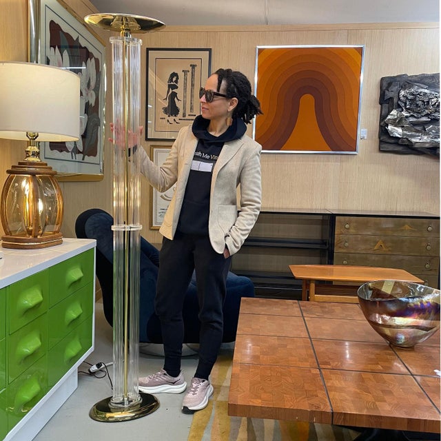 Ultra glam Art Deco inspired, Nineteen-Laties, clear acrylic floor lamp with gold metallic accents. As the room is warmly...