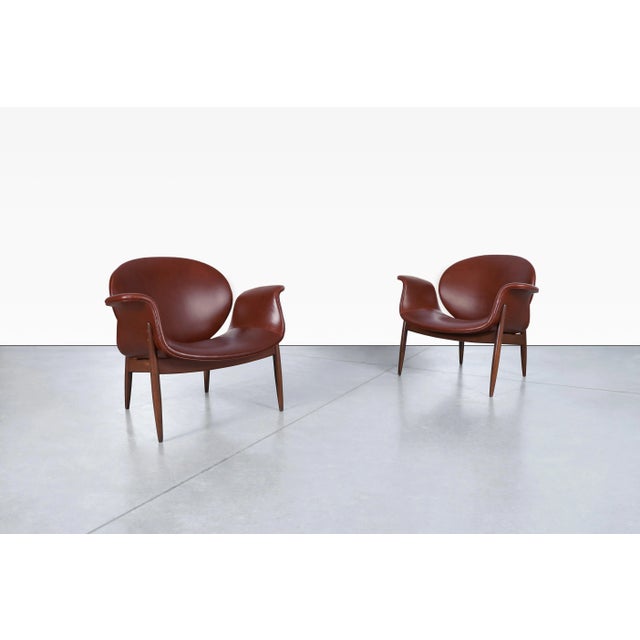 Amazing vintage leather and walnut “Swan” lounge chairs designed by Arthur Umanoff for Madison Furniture in the United...
