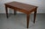 This writing table was designed and made in France from walnut wood around the 1920s. It features two drawers and has nice...