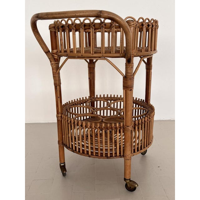Gorgeous bar cart or trolley made of curved bamboo and rattan during the Italian mid-century in the 1960s. The cart is...