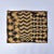 A square(ish) raffia textile. Decorated with geometric designs, the varying fiber lengths create a lovely texture. These...