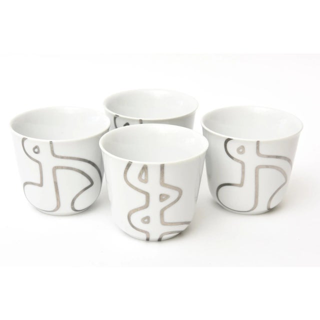 This contemporary set of 4 Royal Copenhagen porcelain white bowls or vessels with silver design are and are hallmarked on...