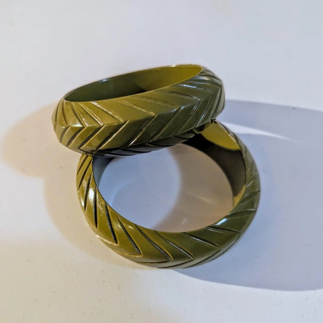 Late 80's pair of incised with leaflike design. The color is a vibrant olive green. Linnear lines together lmost a zig zag...