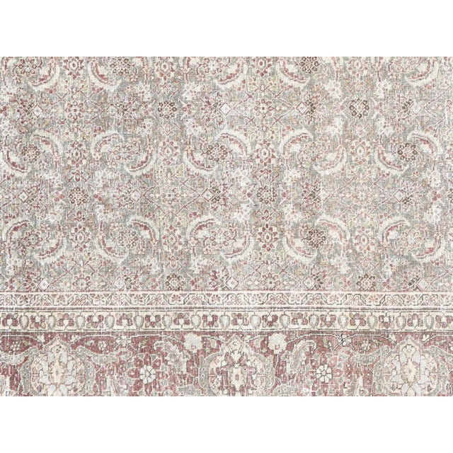 Expertly handcrafted in Tabriz, Iran, this semi-antique Persian rug boasts intricate designs and luxurious wool...