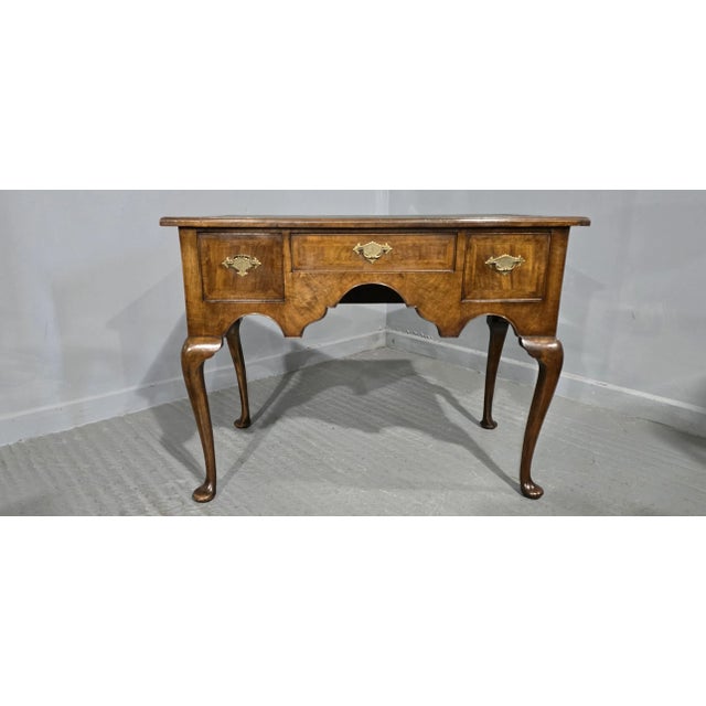 A very nice burr walnut lowboy, dressing table or desk, Queen Anne style, three drawers with brass handles, green leather...