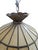 Beautiful vintage 1970s Tiffany-style hanging pendant light featuring cream slag-glass panels accented by textured amber...