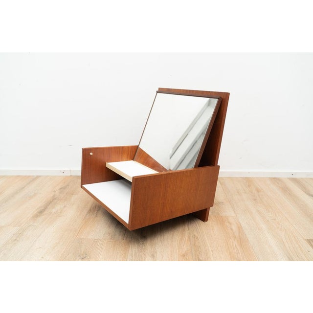 Model EU11 Nightstand by Cees Braakman. The nightstand comes with a foldable mirror and a shelf underneath. The nightstand...