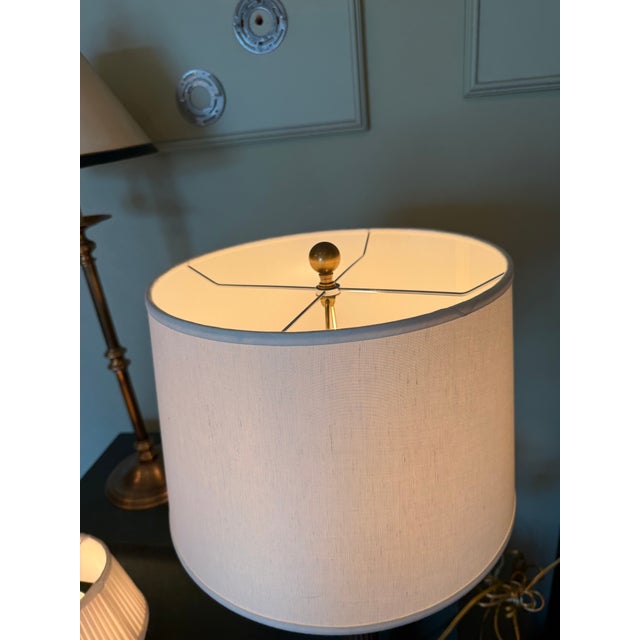 A Haig table lamp featuring a fluted column design with brass accents and a stepped square base. The architectural form...