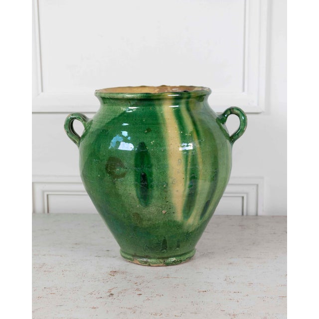 Made in France around 1840, this confit pot is finished in a green glaze with a yellow splash. Confit pots were everyday...