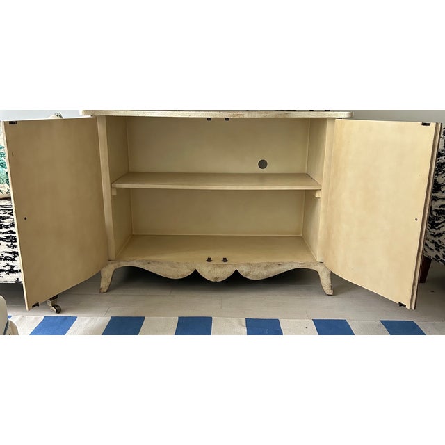 Elegant Ardley Hall two-door cabinet featuring a beautifully distressed antiqued cream finish with subtle crackle...