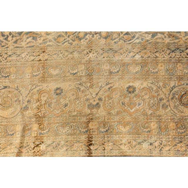 This circa-1920 antique Persian Kirman rug features a strikingly intricate all-over design of arabesques and Oriental...