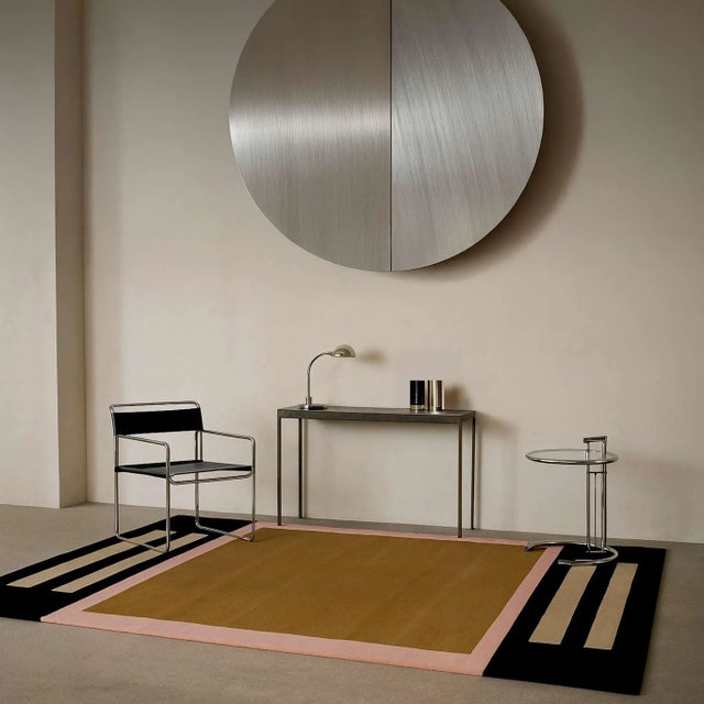 The Rotoko Rug blends golden beige, cream, and soft pink tones into geometric shapes, creating a modern, playful balance....