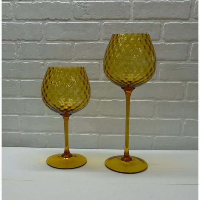 Beautiful pair of large vintage amber blown glass ball vases dating to the 1960s, with a warm golden hue and softly waved...