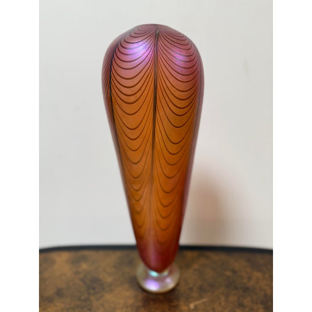 Design Plus Gallery presents a Signed Ken Peterson Glass Vase. Hand blown in flame orange + iridescent spiraling of...