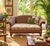 Striking late-20th-century British Colonial-style woven rattan loveseat featuring an exceptionally detailed sculptural...