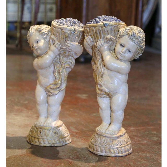 Decorate a wine cellar or a wet bar with this elegant matching pair of antique cherub carvings, with child Bacchus god of...