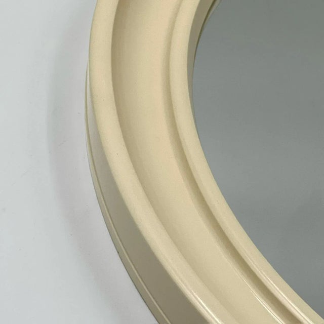 This 70s Carrara & Matta 'America' wall mirror is a standout piece of Italian design, crafted from durable beige bakelite...