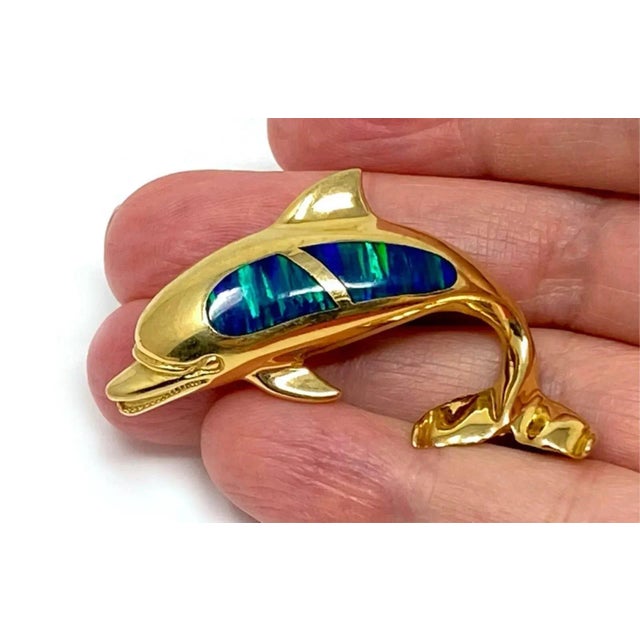 This is an impressive looking half dimensional dolphin pendant, it is crafted from 14k yellow gold with a curved tail and...