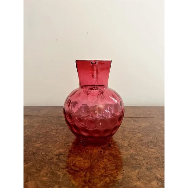 Unusual antique Victorian quality cranberry glass jug having an unusual square shaped top and a shaped handle to the back....
