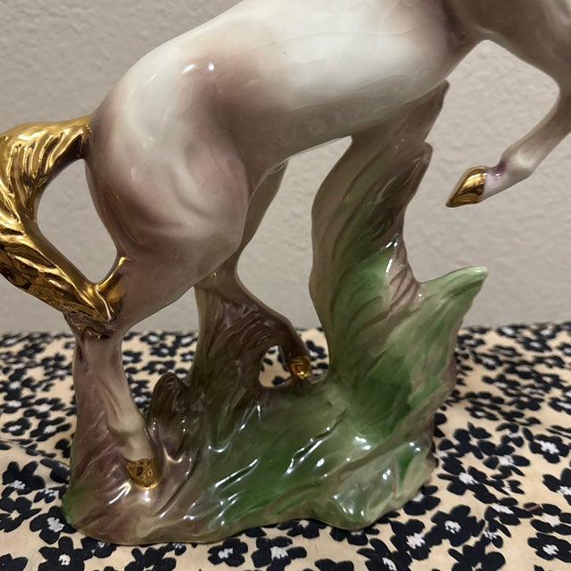 This dramatic porcelain rearing horse exemplifies the bold sculptural décor popular in mid-century American interiors....