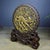 This vintage table screen is carved from sandalwood and features a central roundel in relief, depicting a qilin — a...