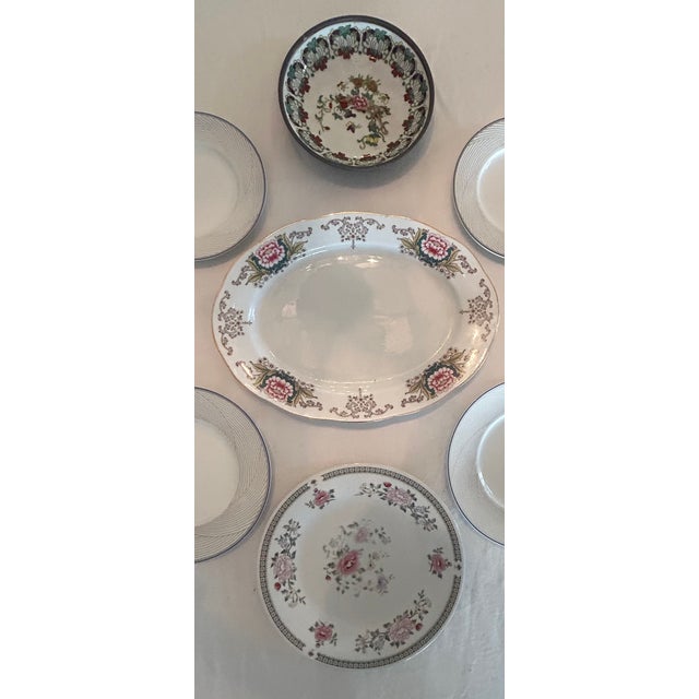 Flower power! This vintage curation of plates in delicate pinks, lavender, and green is set off beautifully by the dove...