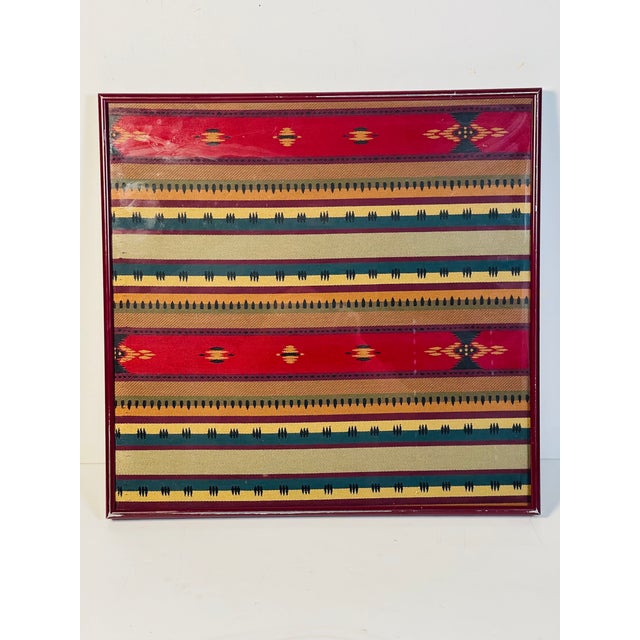 Beautifully woven and color matched textile art sample in vine red frame.
