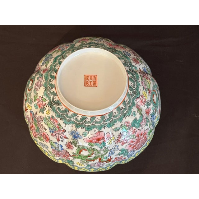 A stunning early 20th-century Chinese Famille Rose porcelain bowl, delicately hand-painted with vibrant floral sprays,...