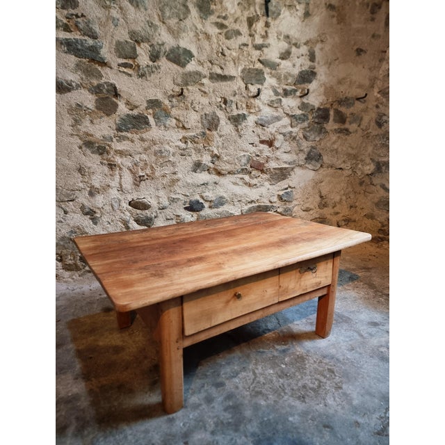 An 18th-century coffee table crafted from solid cherrywood, traditionally referred to as a “money table”. The table is...