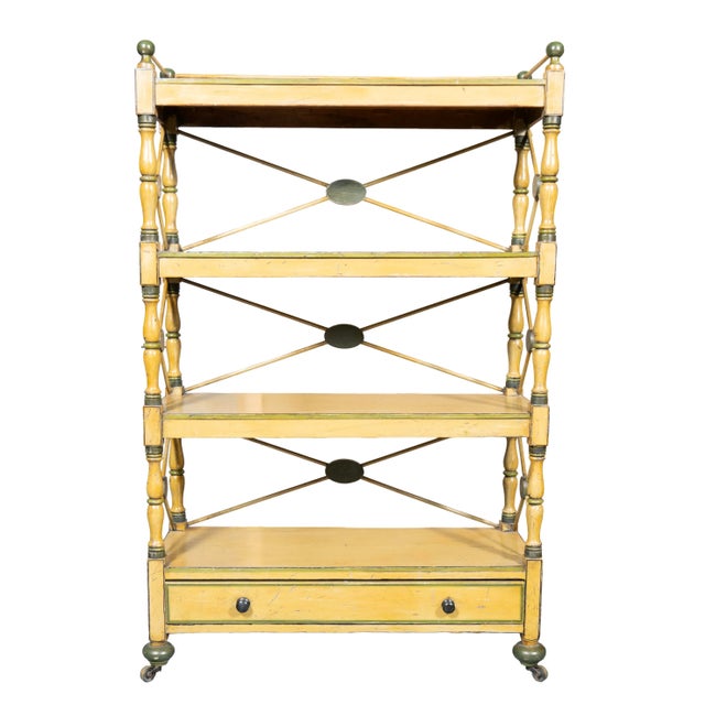 Rectangular top shelf with stick and ball gallery over two free shelves and base shelves containing a drawer. Toupie feet....