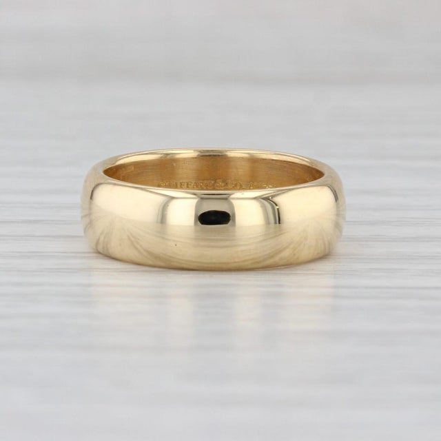 This classic polished wedding band is part of the Tiffany & Co Forever collection. This estate piece has a retail of...