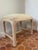 Elevate your space with a touch of organic Postmodern luxury with this vintage 1980s pencil reed rattan vanity stool bench...