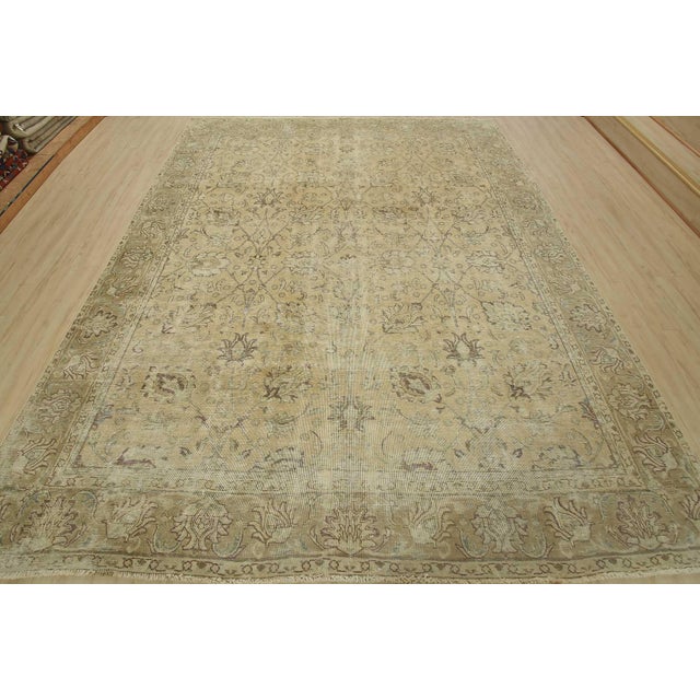 An authentic vintage traditional Tabriz rug hand-knotted with an all-wool pile on a cotton foundation. This oriental rug...