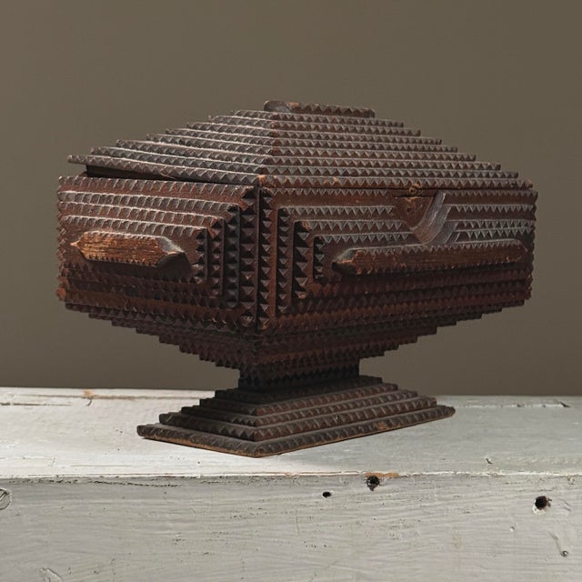 Object: Antique Tramp Art Box on Pedestal Base Dimensions: 10.25” (W) x 7” (H) x 6.75” (D) Materials: Softwood (likely...