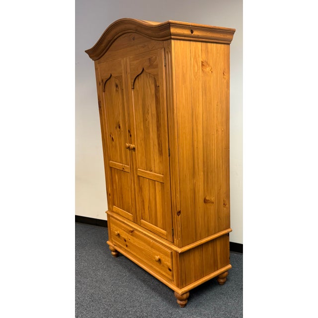 Beautifully crafted Ethan Allen farmhouse-style armoire featuring solid pine construction with a warm, honey-amber finish...