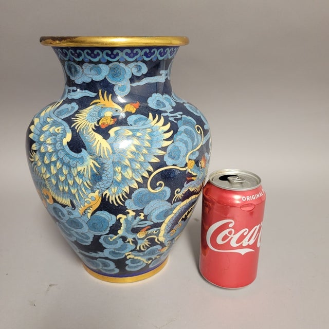 A striking Chinese cloisonné enamel vase featuring the eternal pairing of dragon and phoenix, symbols of harmony and...