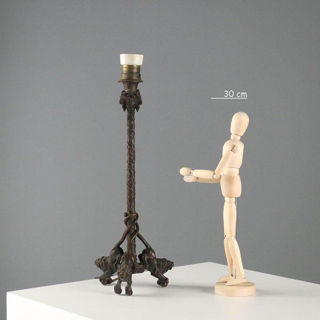 Bronze lamp in the style of Christophe Fratin (1801-1864). The base features three lion figures with tails twisted around...