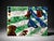Unique abstract mixed media canvas artwork featuring bold green, blue, red, black, white, and gold tones with layered...