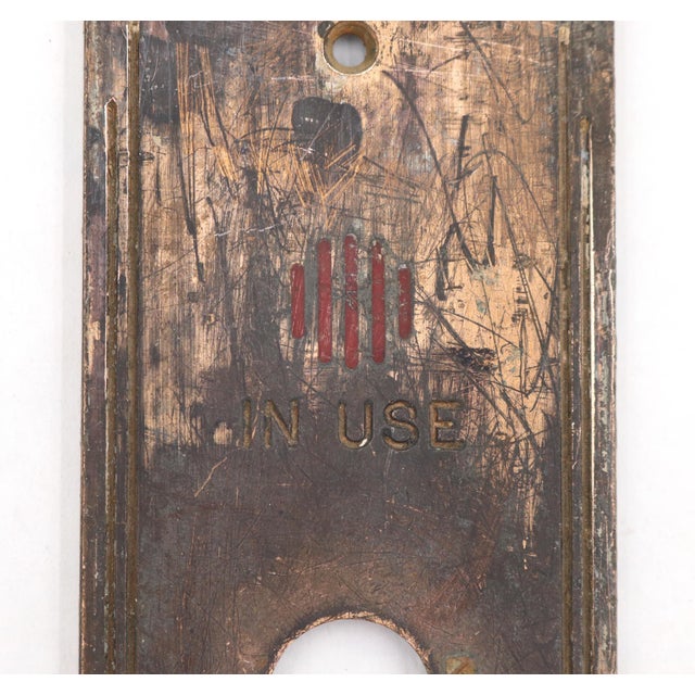 Vintage Art Deco "In Use" elevator plate with a single button cut out. Made of brass with a patina finish. The original...