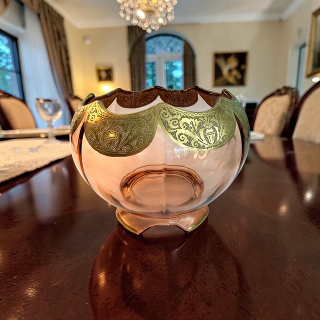 Beautiful peachy pink Depression glass bowl with a scalloped rim etched in gold scrollwork. It could be a true antique. It...