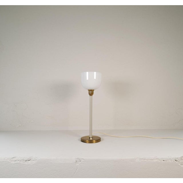 Genuinely nice swedish table lamp made in the 1940s for asea and designed by hans bergström. With a brass base and a hard...