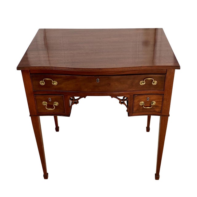 A fine and rare English George III mahogany metamorphic desk. The serpentine case is fitted with a single long drawer over...